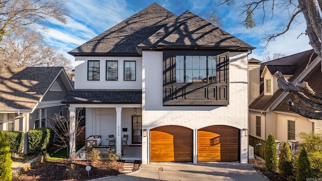 5204 Stonewall Rd, Little Rock, AR 72207 - view of front facade with driveway, stucco siding, and roof with shingles