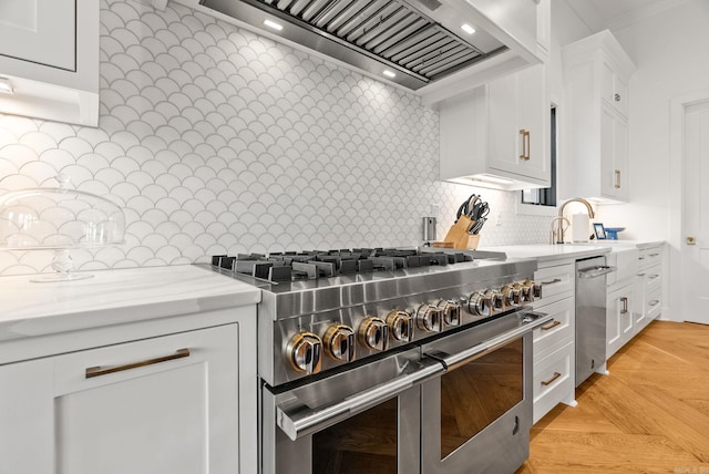 5204 Stonewall Rd, Little Rock, AR 72207 - kitchen with light stone counters, backsplash, double oven range, white cabinetry, and premium range hood