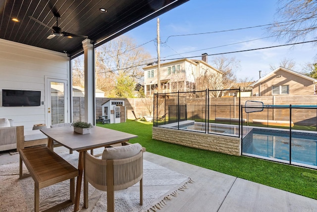 5204 Stonewall Rd, Little Rock, AR 72207 - view of patio / terrace with a fenced backyard, outdoor dining area, ceiling fan, and a fenced in pool
