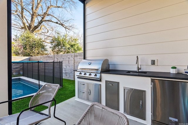 5204 Stonewall Rd, Little Rock, AR 72207 - view of patio with an outdoor kitchen, a sink, a fenced in pool, area for grilling, and a fenced backyard
