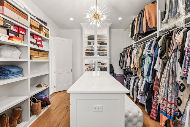 5204 Stonewall Rd, Little Rock, AR 72207 - walk in closet featuring light wood finished floors and an inviting chandelier