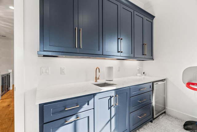 5204 Stonewall Rd, Little Rock, AR 72207 - interior space featuring baseboards, a sink, blue cabinetry, and beverage cooler