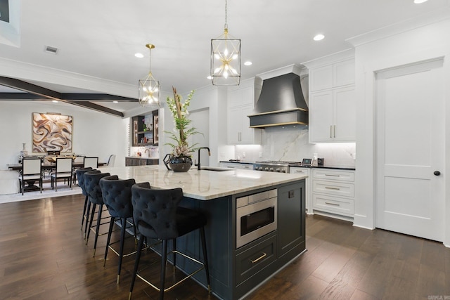 125 Hallen Ln, Little Rock, AR 72223 - kitchen with decorative backsplash, visible vents, stainless steel microwave, wall chimney exhaust hood, and white cabinetry