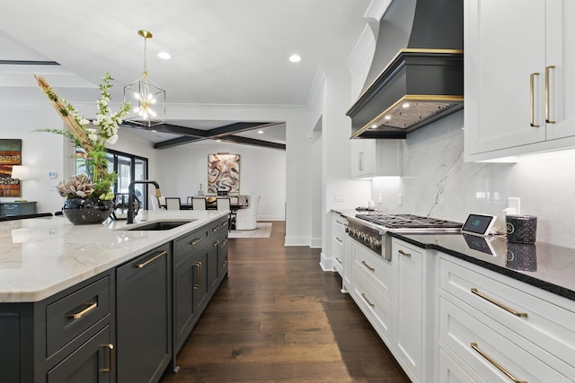 125 Hallen Ln, Little Rock, AR 72223 - kitchen featuring stainless steel gas cooktop, light stone counters, a sink, custom range hood, and dark wood-style flooring