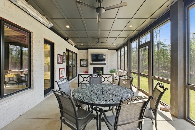 125 Hallen Ln, Little Rock, AR 72223 - sunroom / solarium with ceiling fan, outdoor dining area, and exterior fireplace