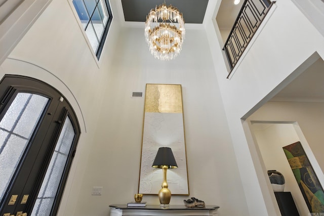 125 Hallen Ln, Little Rock, AR 72223 - foyer entrance featuring visible vents, a high ceiling, and an inviting chandelier