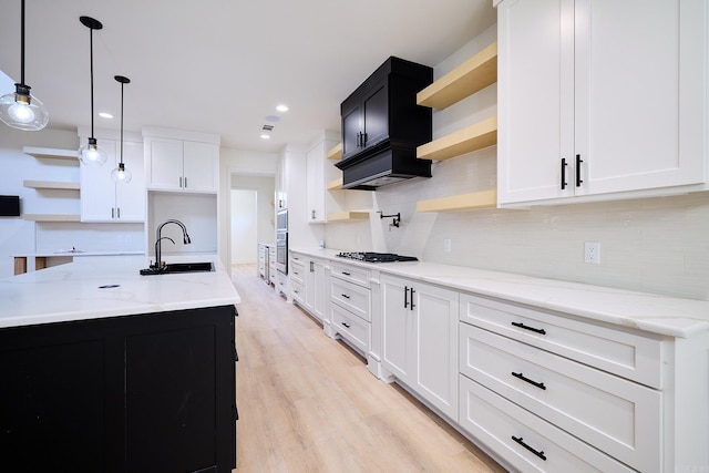 9 Marchwood Cv, Little Rock, AR 72210 - kitchen featuring open shelves, gas stovetop, backsplash, a sink, and light wood-style floors
