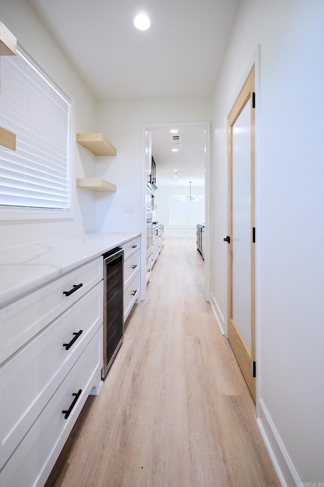 9 Marchwood Cv, Little Rock, AR 72210 - corridor featuring recessed lighting, baseboards, beverage cooler, light wood finished floors, and visible vents