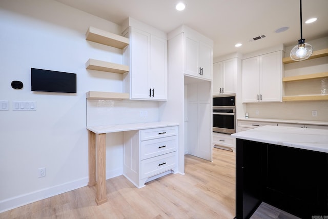 9 Marchwood Cv, Little Rock, AR 72210 - kitchen with light stone countertops, visible vents, open shelves, and appliances with stainless steel finishes