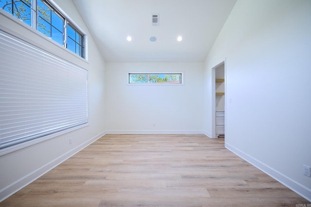 9 Marchwood Cv, Little Rock, AR 72210 - unfurnished room featuring vaulted ceiling, baseboards, visible vents, light wood-style floors, and recessed lighting