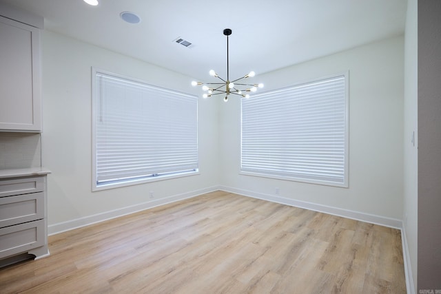 9 Marchwood Cv, Little Rock, AR 72210 - unfurnished dining area with baseboards, visible vents, light wood-type flooring, and a chandelier