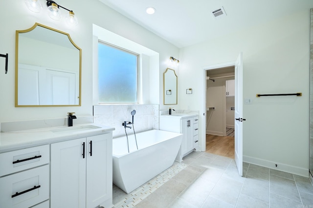 9 Marchwood Cv, Little Rock, AR 72210 - full bath with visible vents, a sink, tile patterned floors, and a freestanding bath