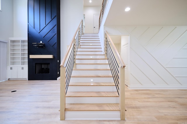 9 Marchwood Cv, Little Rock, AR 72210 - staircase with a large fireplace, recessed lighting, and wood finished floors