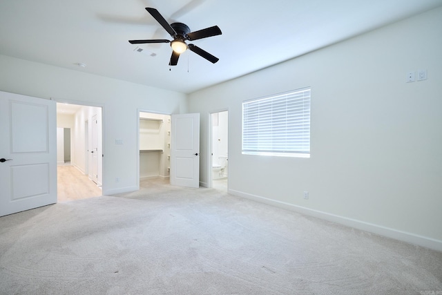 9 Marchwood Cv, Little Rock, AR 72210 - unfurnished bedroom featuring visible vents, baseboards, connected bathroom, light carpet, and a walk in closet