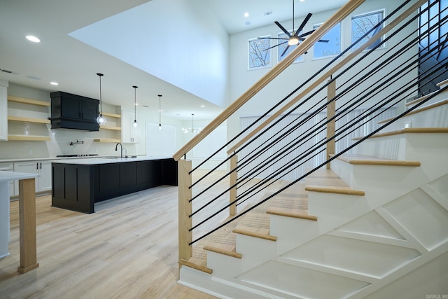 9 Marchwood Cv, Little Rock, AR 72210 - stairway with a ceiling fan, wood finished floors, visible vents, a towering ceiling, and recessed lighting