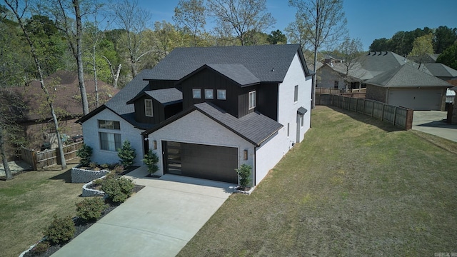 9 Marchwood Cv, Little Rock, AR 72210 - view of front of home featuring fence, a front lawn, board and batten siding, and concrete driveway