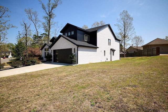 9 Marchwood Cv, Little Rock, AR 72210 - view of side of home with concrete driveway, fence, board and batten siding, brick siding, and a lawn