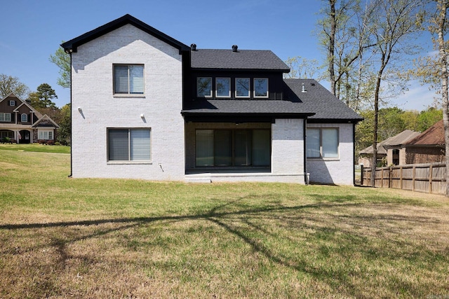 9 Marchwood Cv, Little Rock, AR 72210 - rear view of house featuring brick siding, fence, a shingled roof, and a yard