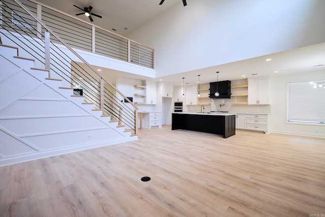 9 Marchwood Cv, Little Rock, AR 72210 - unfurnished living room featuring stairs, recessed lighting, baseboards, light wood finished floors, and ceiling fan
