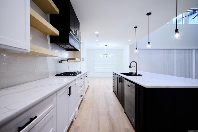 9 Marchwood Cv, Little Rock, AR 72210 - kitchen with dark cabinetry, gas stovetop, a sink, dishwasher, and light wood-style flooring
