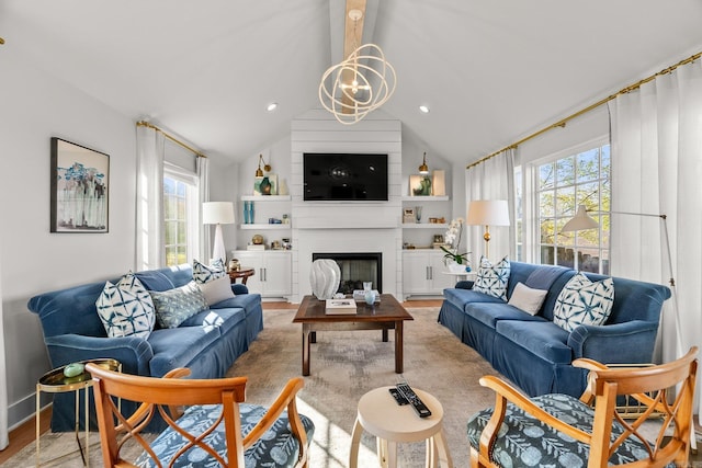 living room with baseboards, a large fireplace, a notable chandelier, vaulted ceiling with beams, and wood finished floors