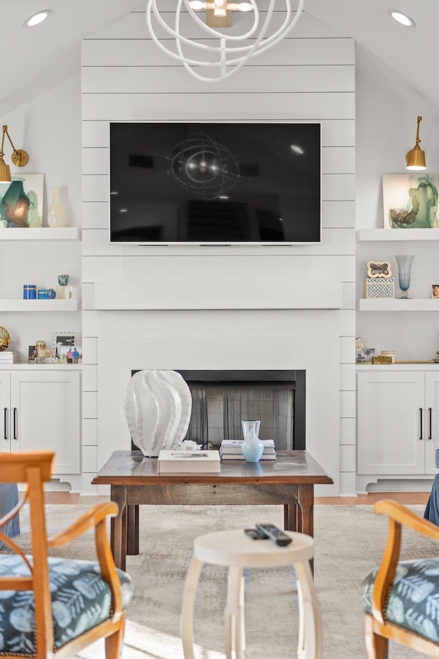 living room with lofted ceiling, a fireplace, and recessed lighting