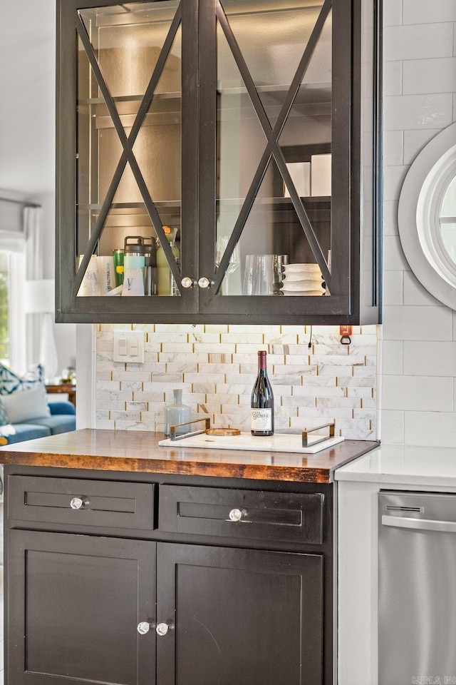 bar with tasteful backsplash and stainless steel dishwasher