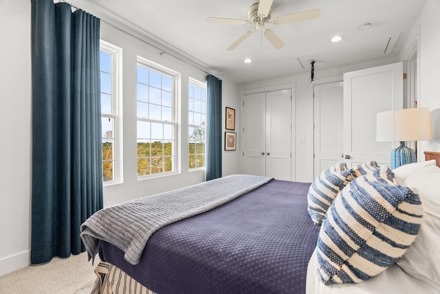carpeted bedroom featuring a closet, attic access, ceiling fan, and recessed lighting