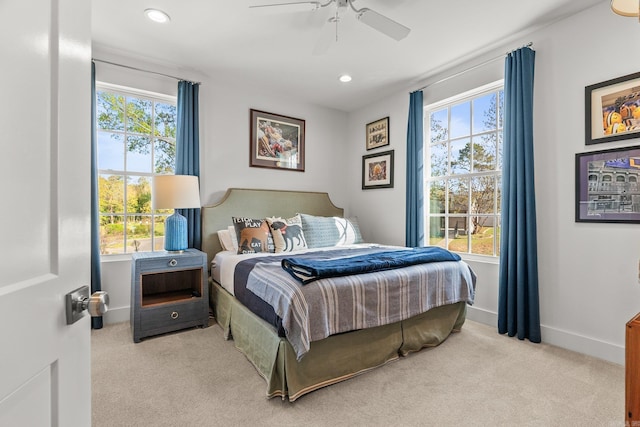 bedroom featuring baseboards, carpet floors, and multiple windows