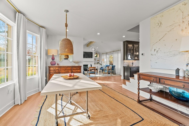 dining space with light wood-style flooring, baseboards, a fireplace, and recessed lighting
