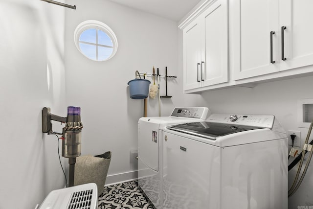 laundry room featuring cabinet space, baseboards, and washer and dryer