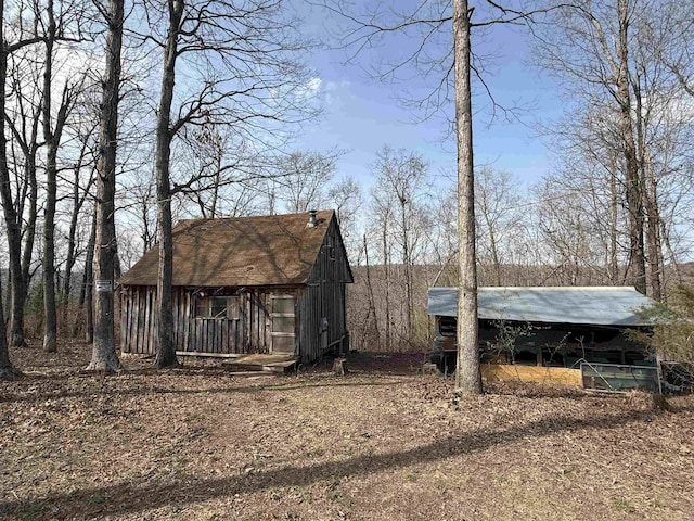 150 Woopsie Dr, Leslie, AR 72645 - view of front of home with an outbuilding and a carport