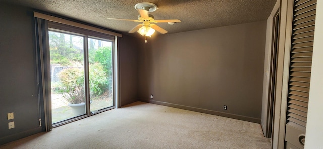 spare room featuring ceiling fan, baseboards, light colored carpet, and a textured ceiling