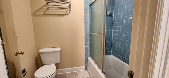 full bathroom featuring tile patterned flooring, shower / bath combination with glass door, toilet, and baseboards