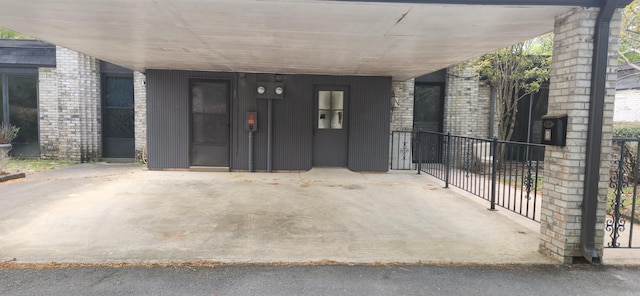 property entrance with a carport and fence