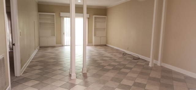 empty room with crown molding and baseboards