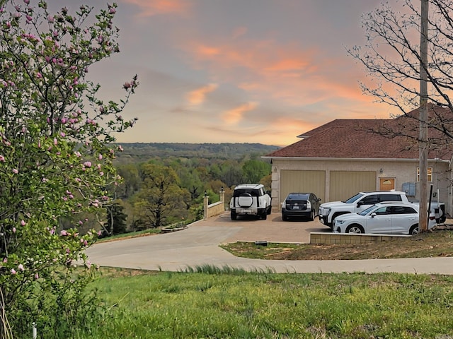 property exterior at dusk featuring driveway