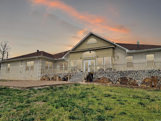 rear view of property with a yard and a deck