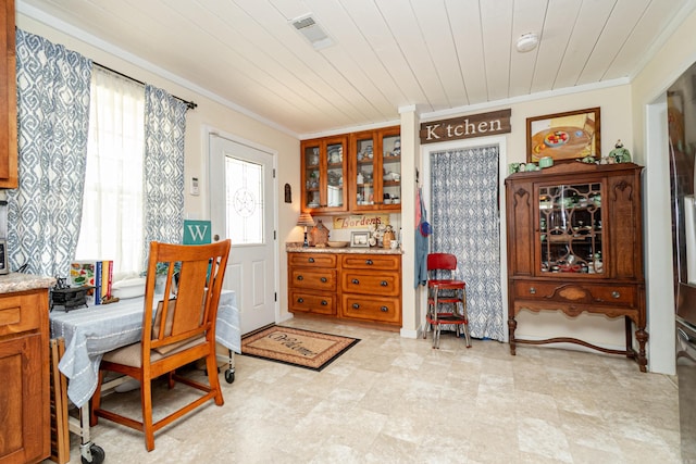 dining room featuring visible vents, crown molding, and wood ceiling