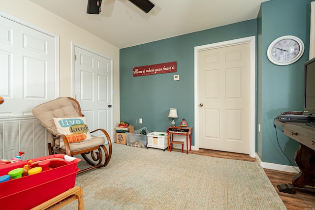bedroom with a ceiling fan, baseboards, and wood finished floors