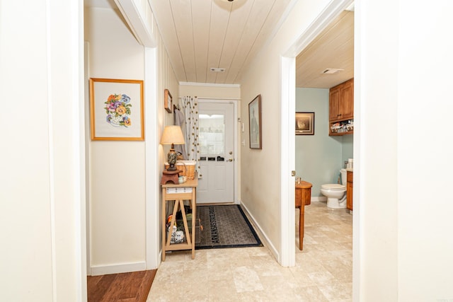 hallway with baseboards and wooden ceiling