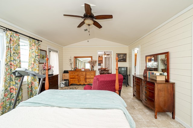 bedroom with lofted ceiling, wood walls, and a ceiling fan