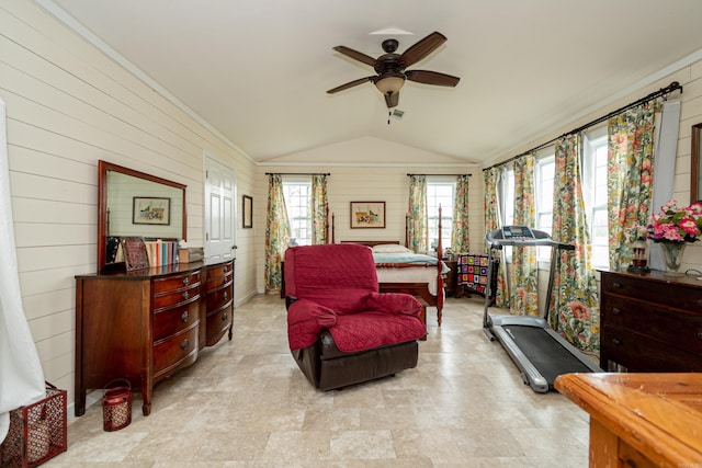 bedroom with wood walls and vaulted ceiling