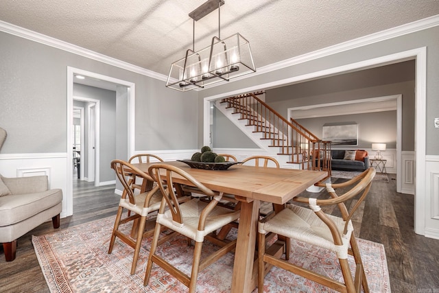 dining room with a textured ceiling, a chandelier, ornamental molding, stairway, and dark wood-type flooring