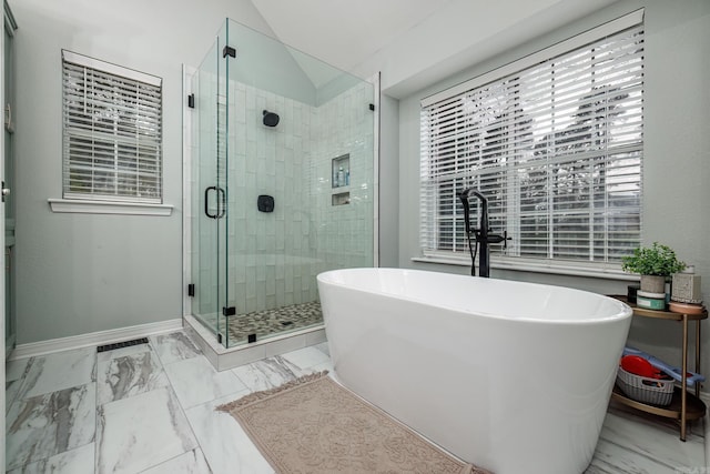 bathroom with marble finish floor, a stall shower, lofted ceiling, and baseboards