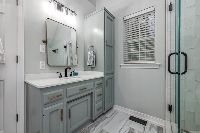 full bath featuring visible vents, a shower stall, baseboards, marble finish floor, and vanity