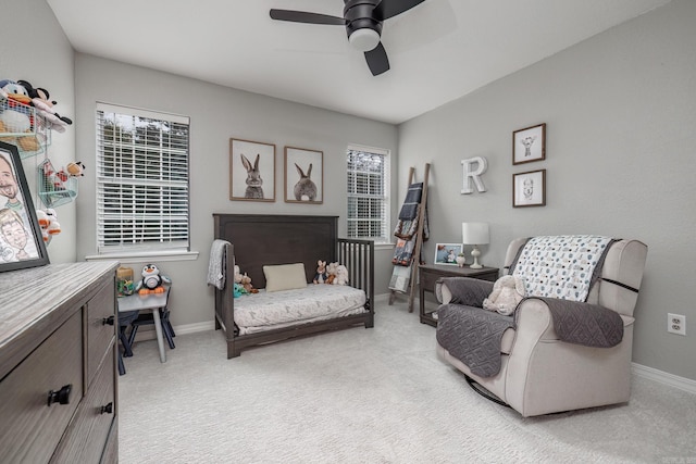 bedroom featuring light carpet, baseboards, and multiple windows
