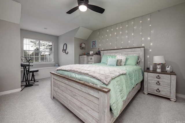 carpeted bedroom with baseboards, lofted ceiling, and ceiling fan