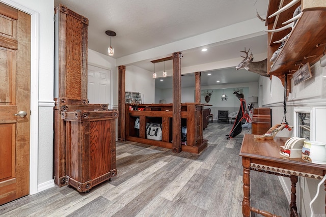 interior space featuring decorative columns and light wood-type flooring