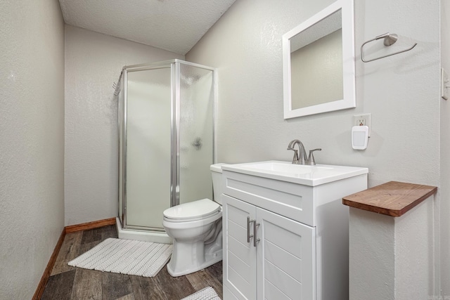 full bath featuring wood finished floors, a stall shower, toilet, and vanity